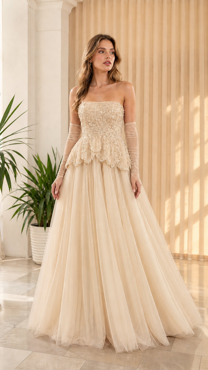 Full-length front view of champagne cream strapless beaded peplum tulle formal dress