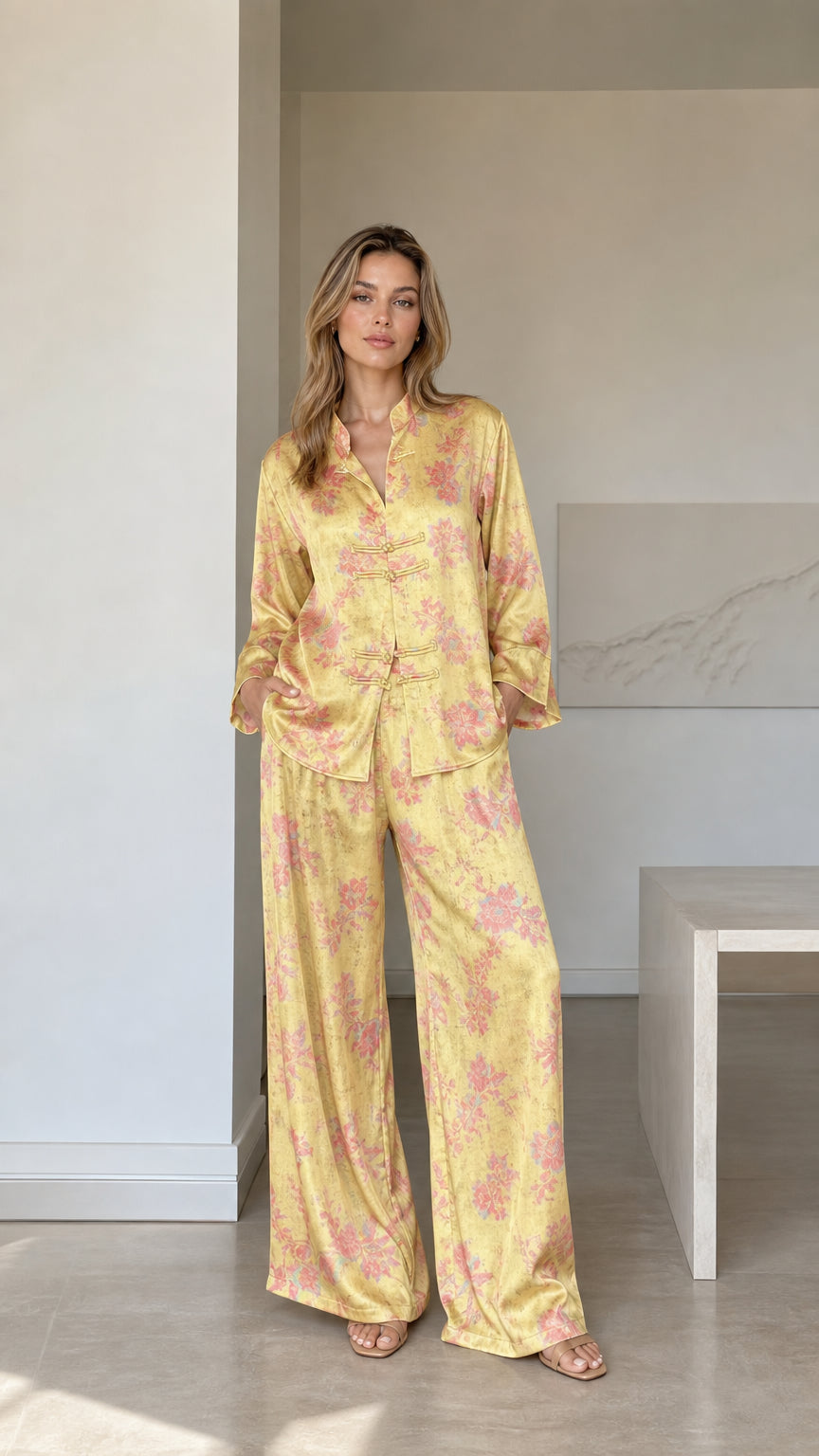 Front full view of woman wearing yellow floral satin mandarin collar pajama set