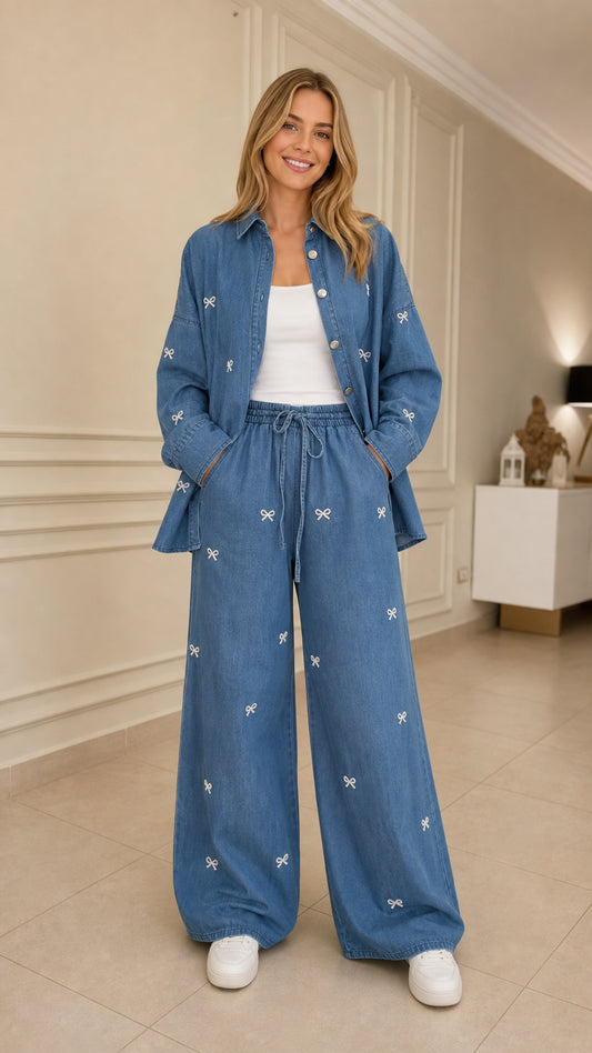 Woman wearing blue bow embroidered denim shirt and wide leg pants set front view