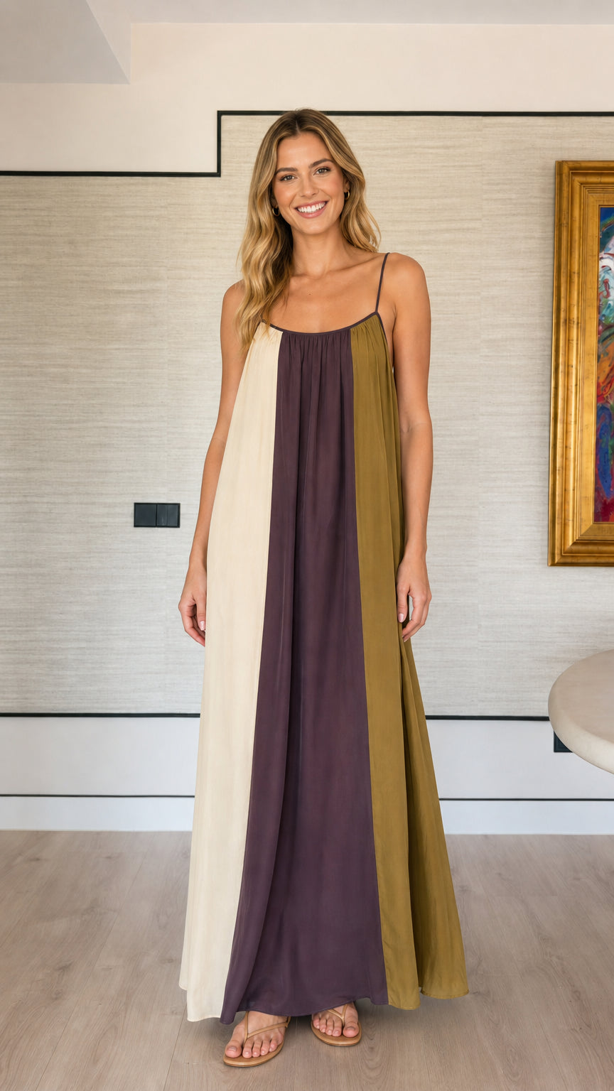 Front view of a woman wearing a plum, ivory, and olive color-block spaghetti strap maxi dress