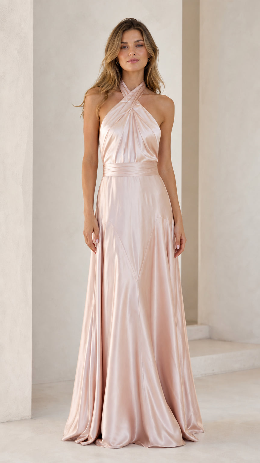 Front view of model wearing Blush Pink halter cross-front satin maxi dress