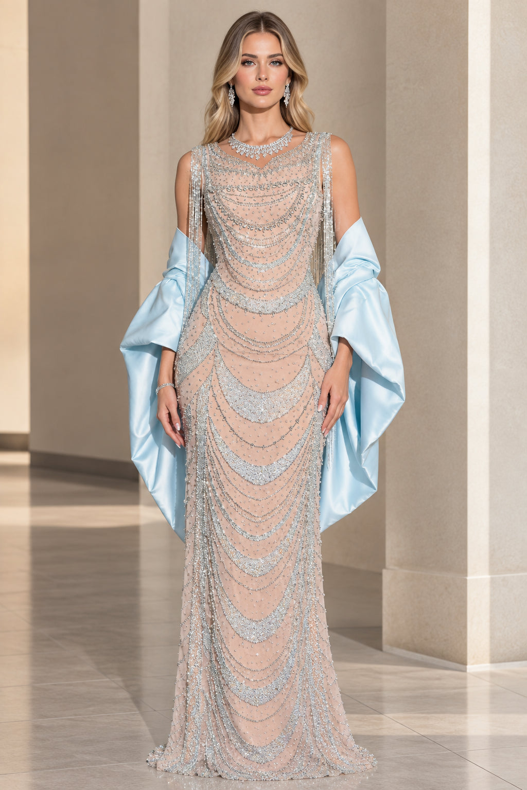 Front view of model wearing champagne scalloped beaded evening gown with light blue satin wrap