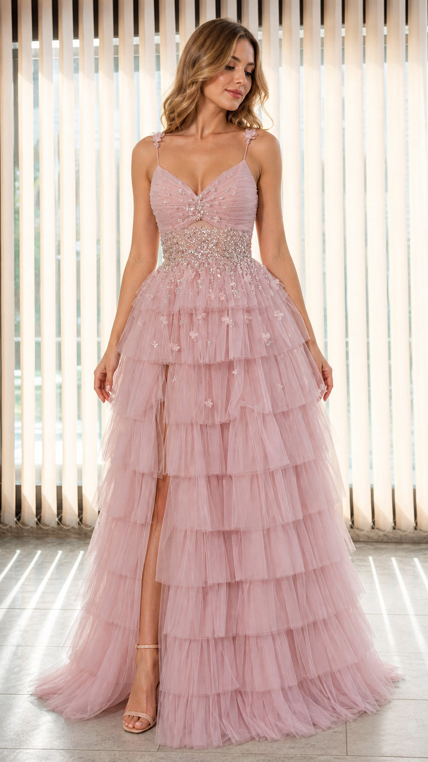 Model wearing Dusty Pink tiered tulle evening gown with beaded waist and high slit front view