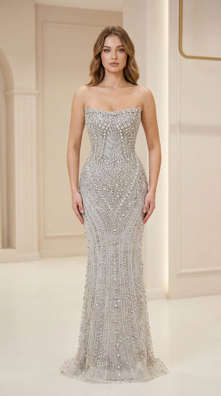 Front view of woman wearing silver strapless beaded evening gown