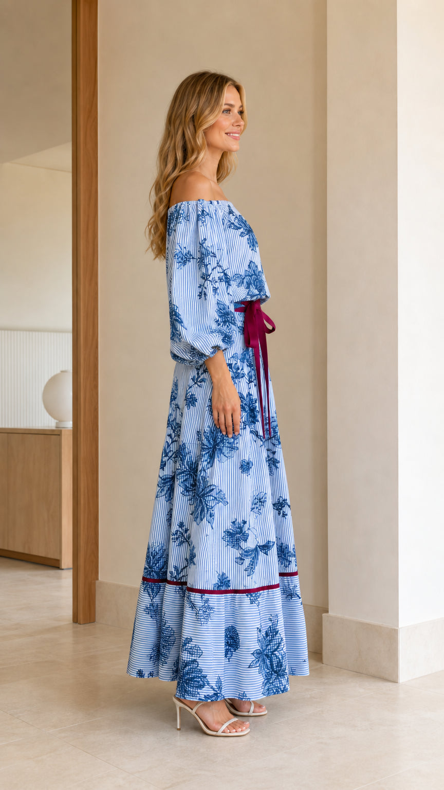 Side profile of model wearing Light Blue off-the-shoulder tiered maxi dress