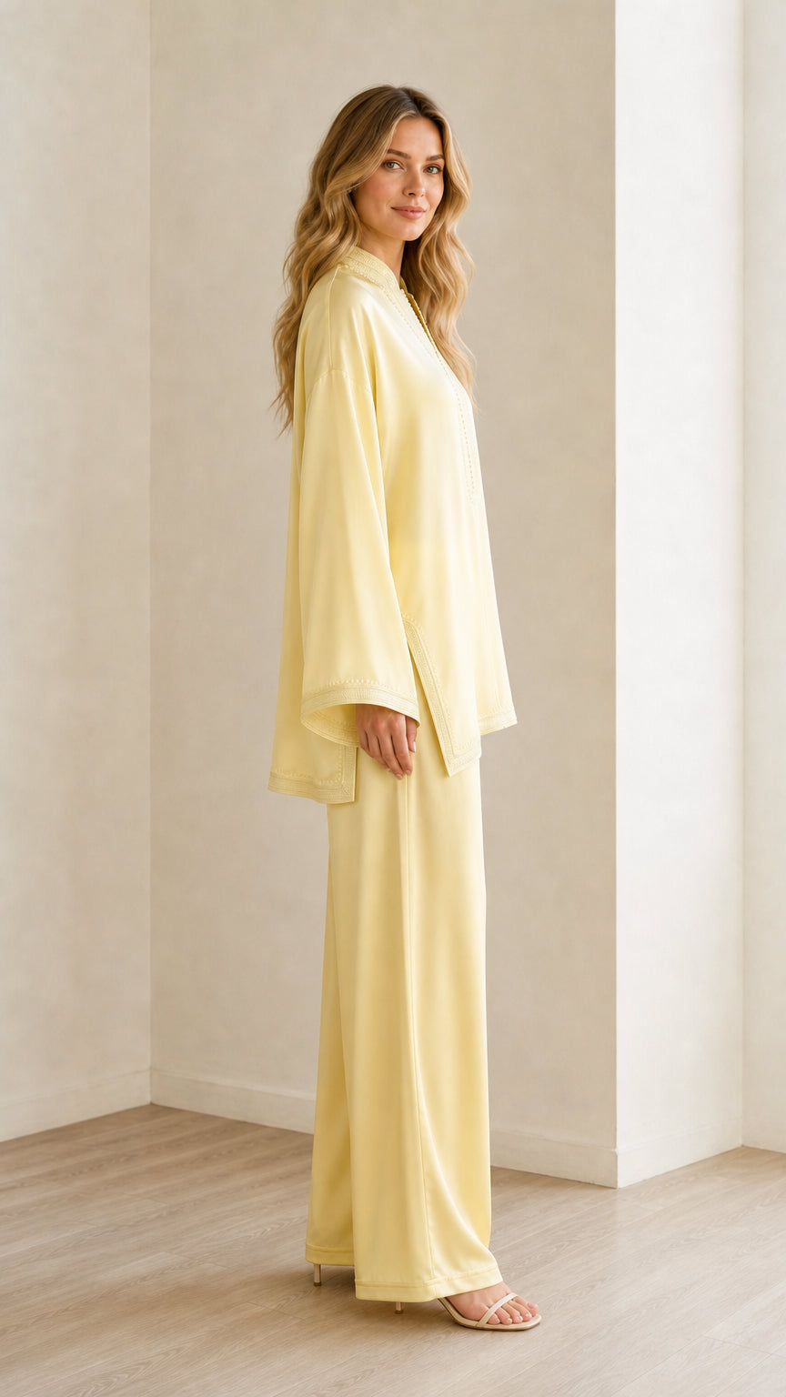 Side profile view of woman modeling the pastel yellow two-piece relaxed fit outfit