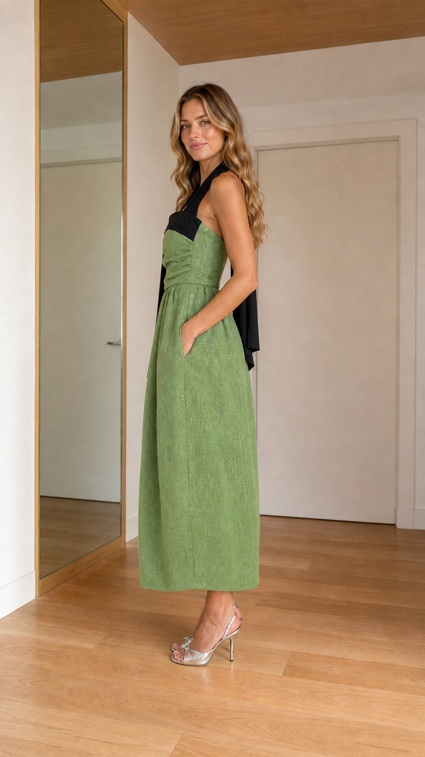 Side profile of woman wearing sage green midi dress showing pocket detail