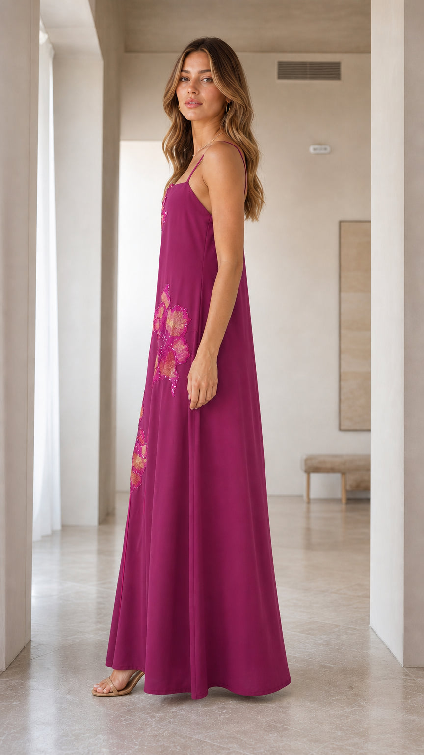 Side profile of magenta sequined spaghetti strap maxi dress