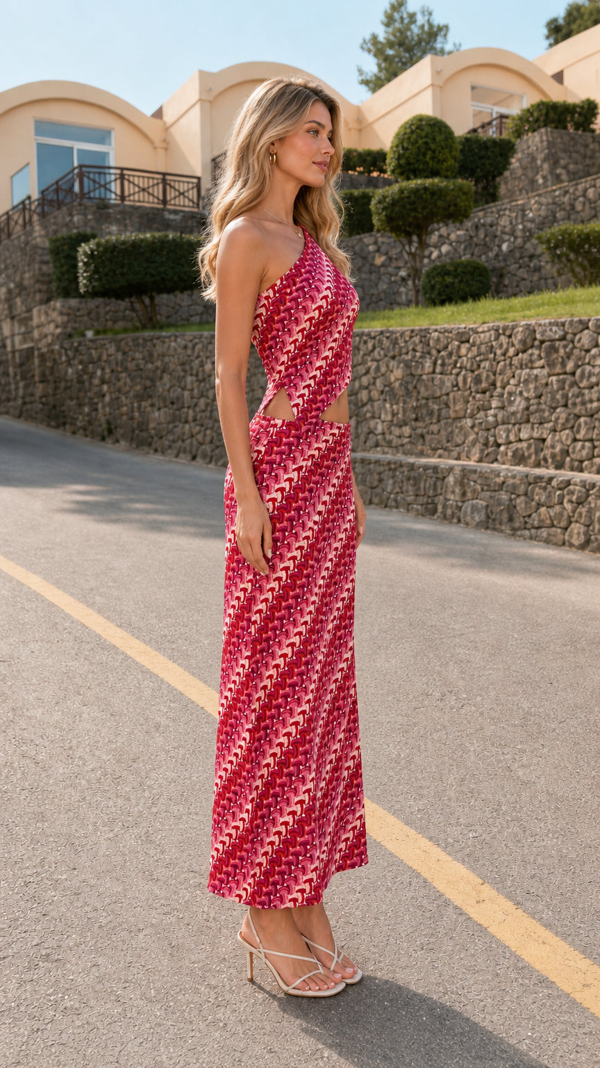 Side profile of model wearing pink one-shoulder cutout printed dress