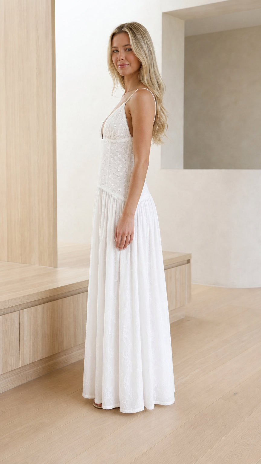 Side profile of model in white sleeveless eyelet maxi dress