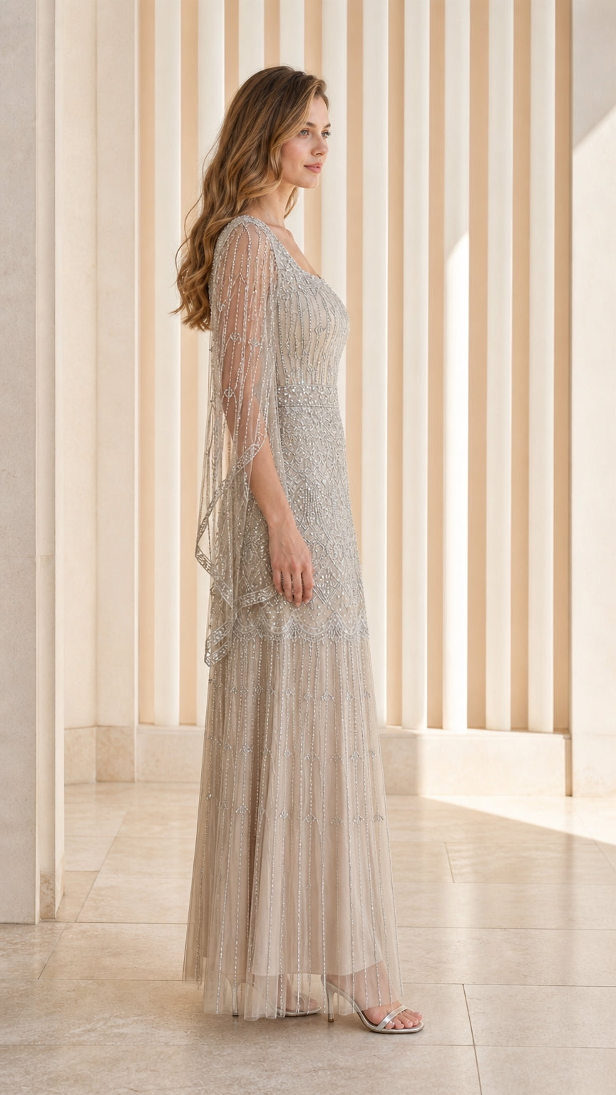 Champagne beaded evening gown side angle view showing draped capelet sleeves