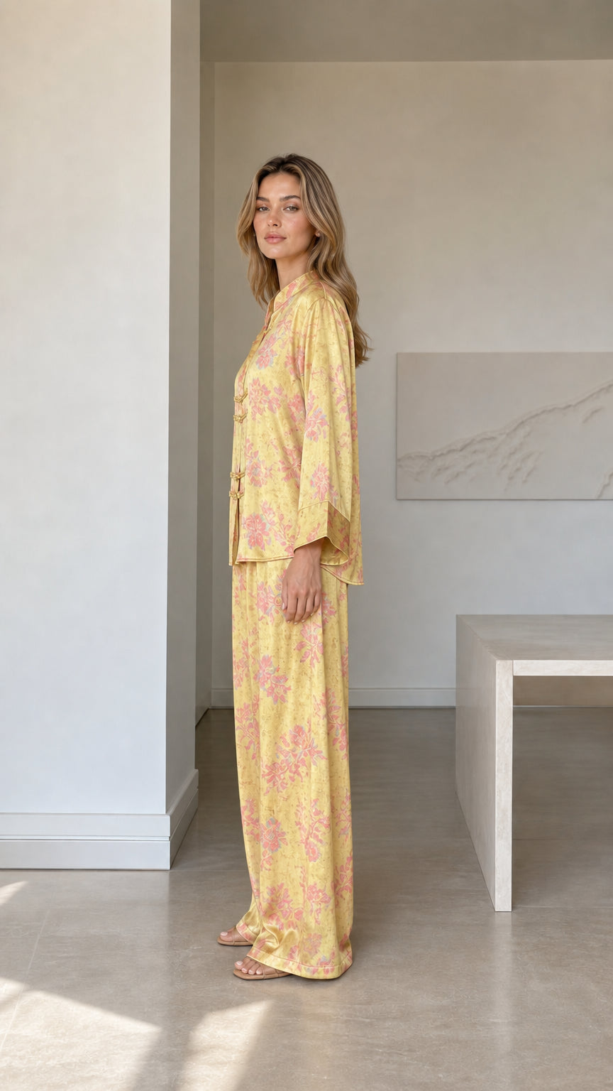 Side profile view of yellow satin floral two-piece loungewear set
