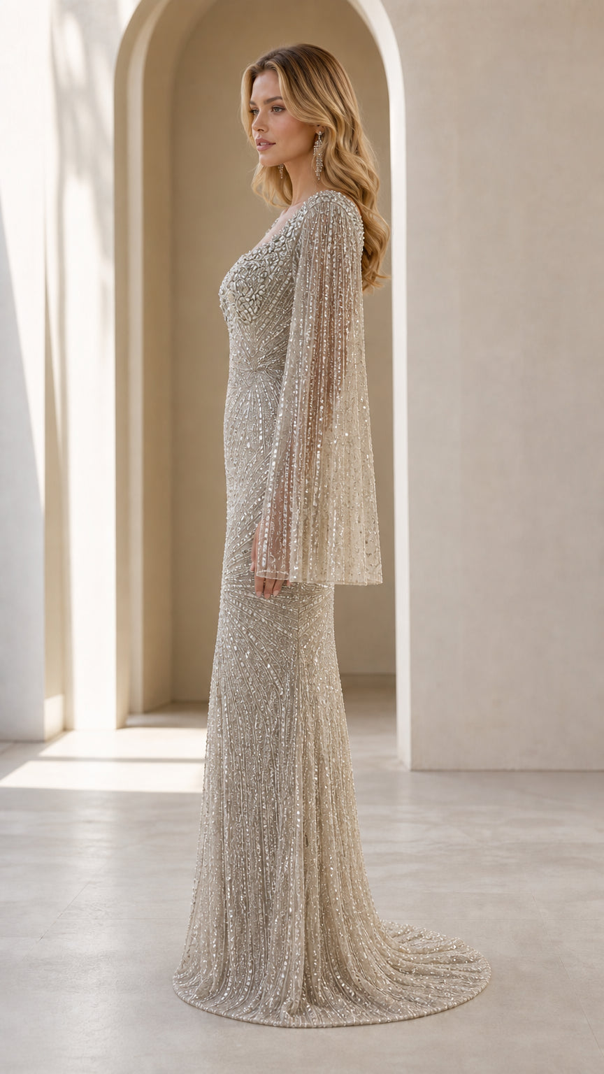 Side profile of champagne beaded evening gown showing sleek fit and sweeping hem