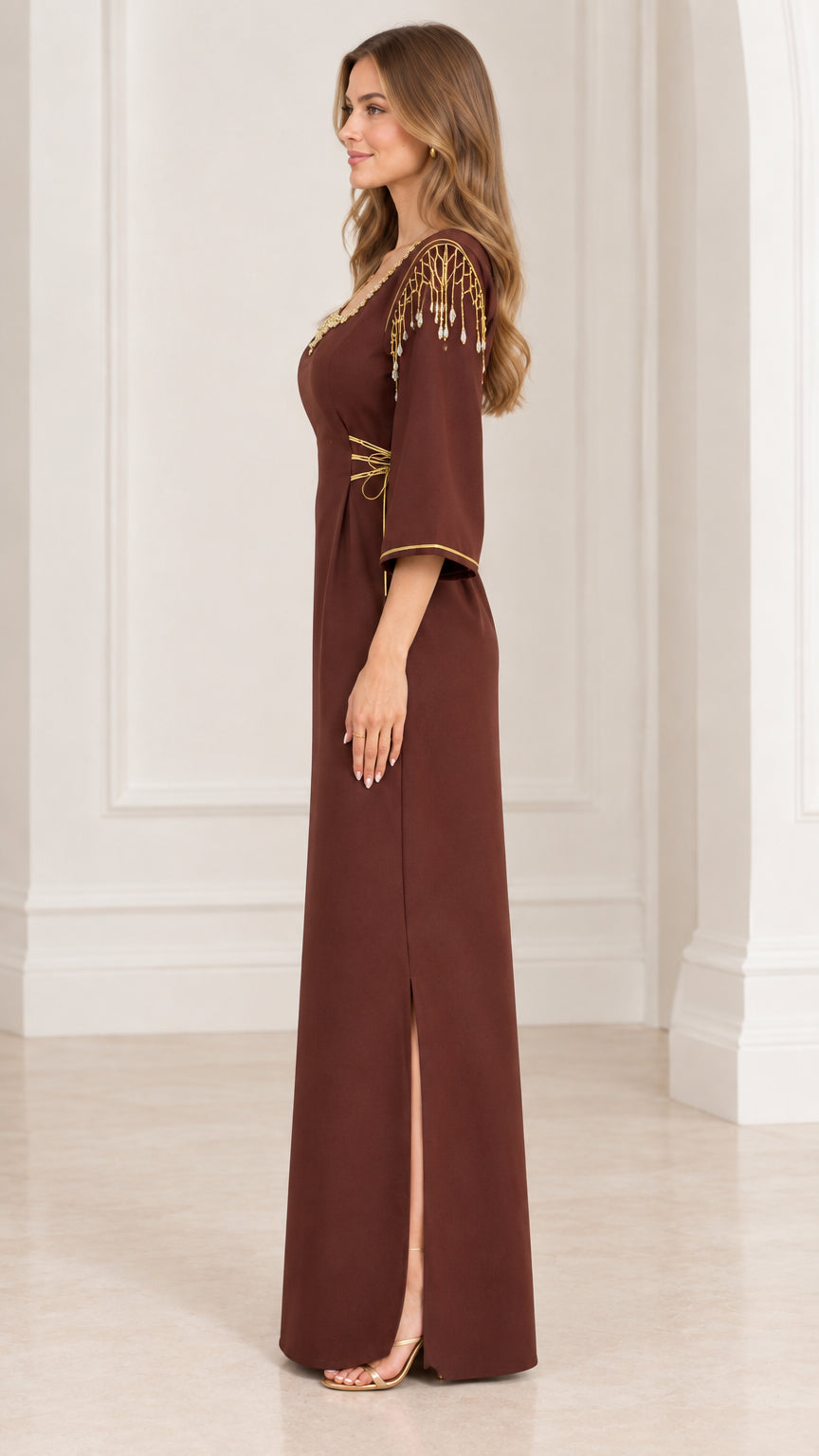Side profile view of brown embellished maxi dress showing side slit and shoulder details