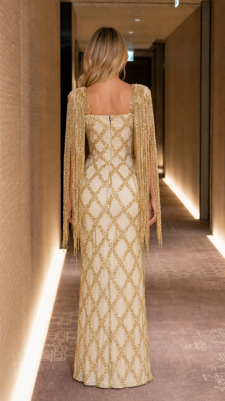 Back view showing zip closure and fringe cape detail