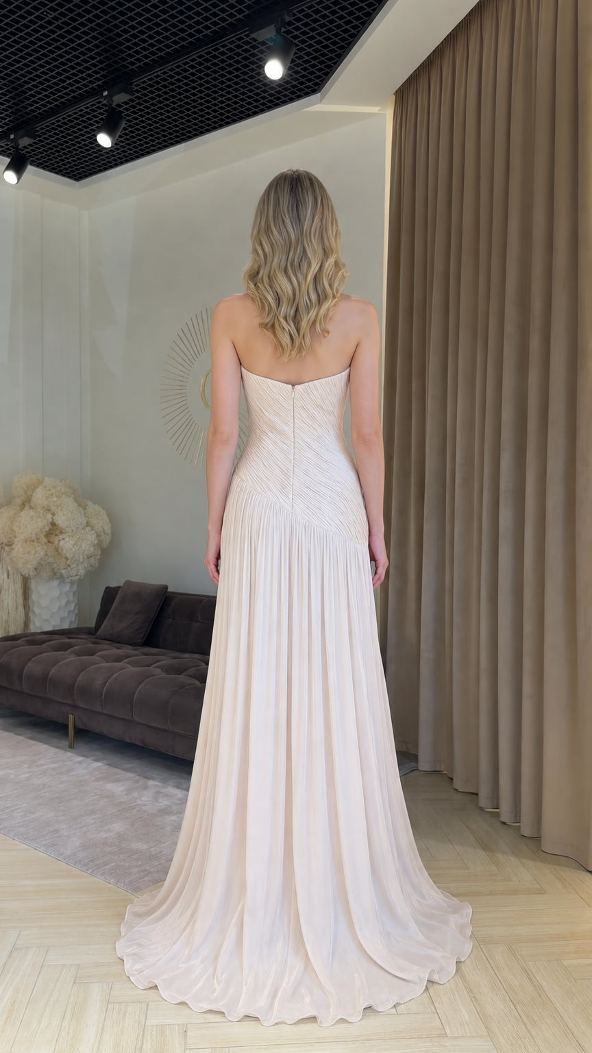 Back view of champagne formal dress showing clean lines and sweeping hem