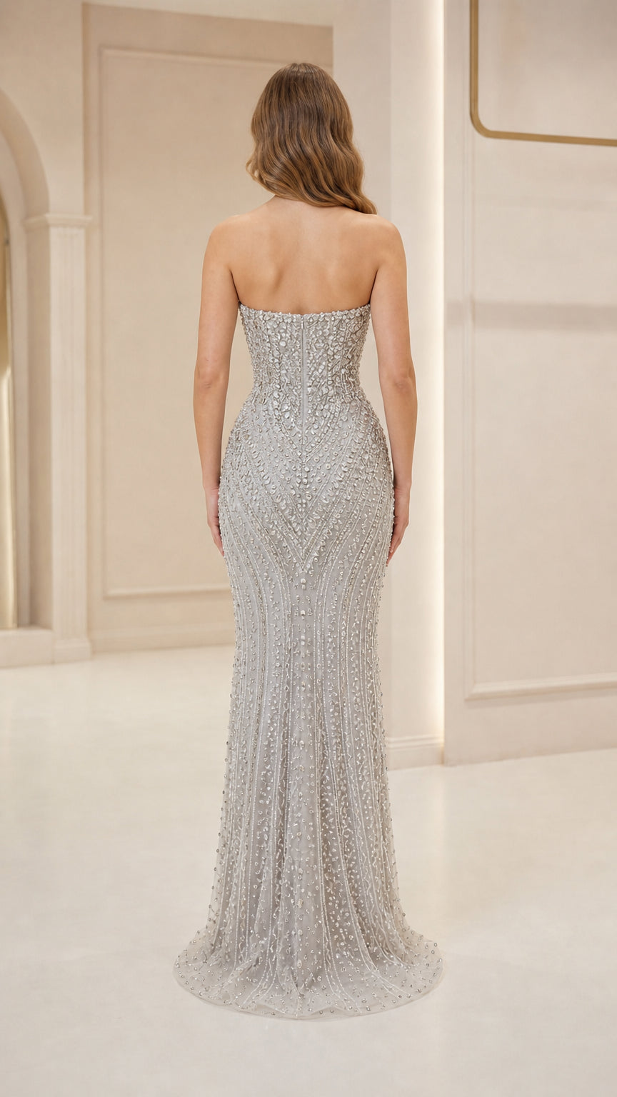 Back view of silver strapless evening gown with subtle train