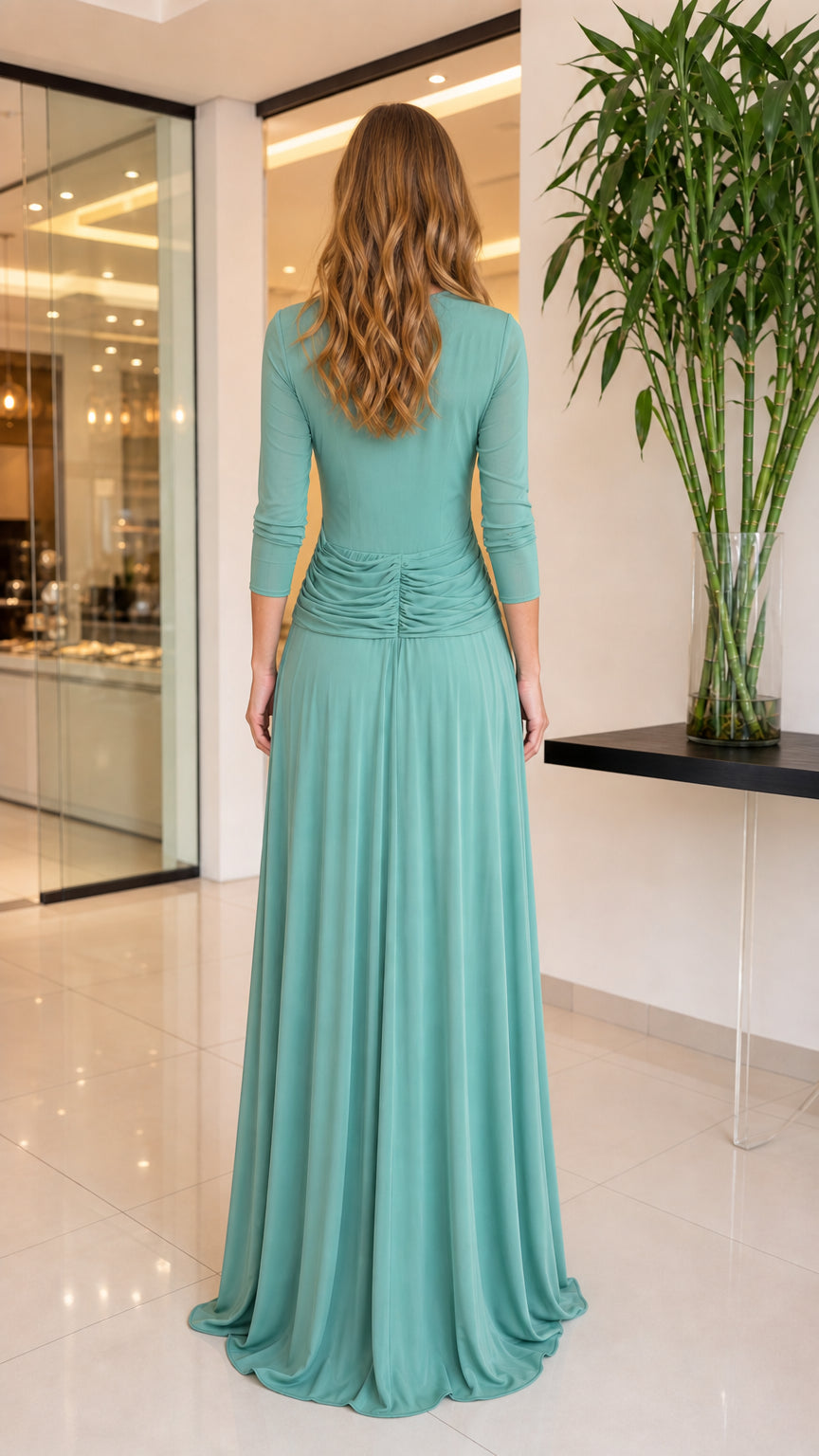 Sage green maxi gown back view showing fitted waist ruching