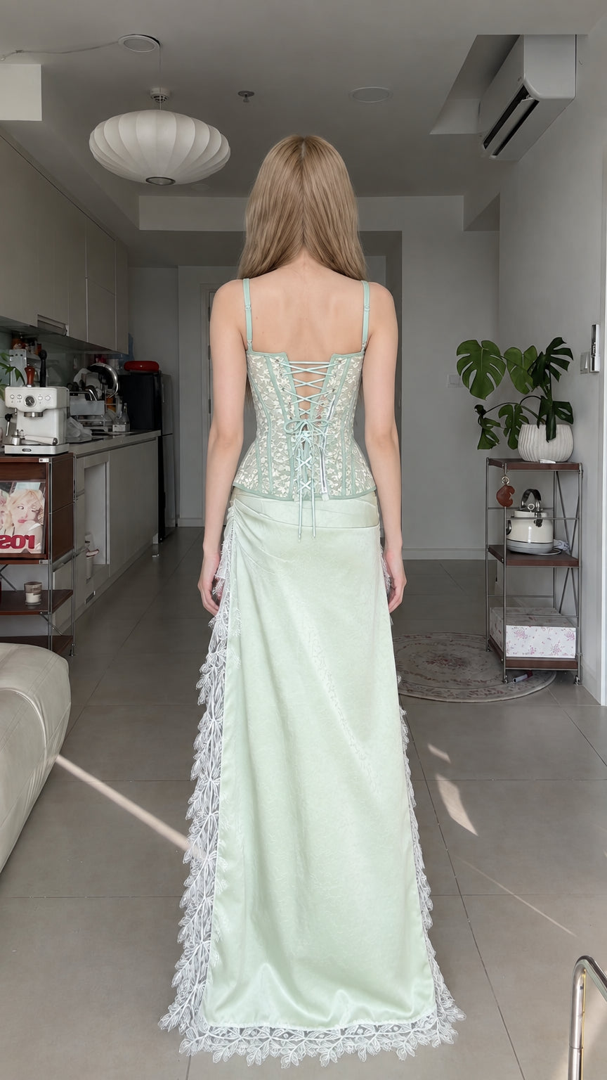 Back view of model showing lace-up corset back and flowing high-low skirt train