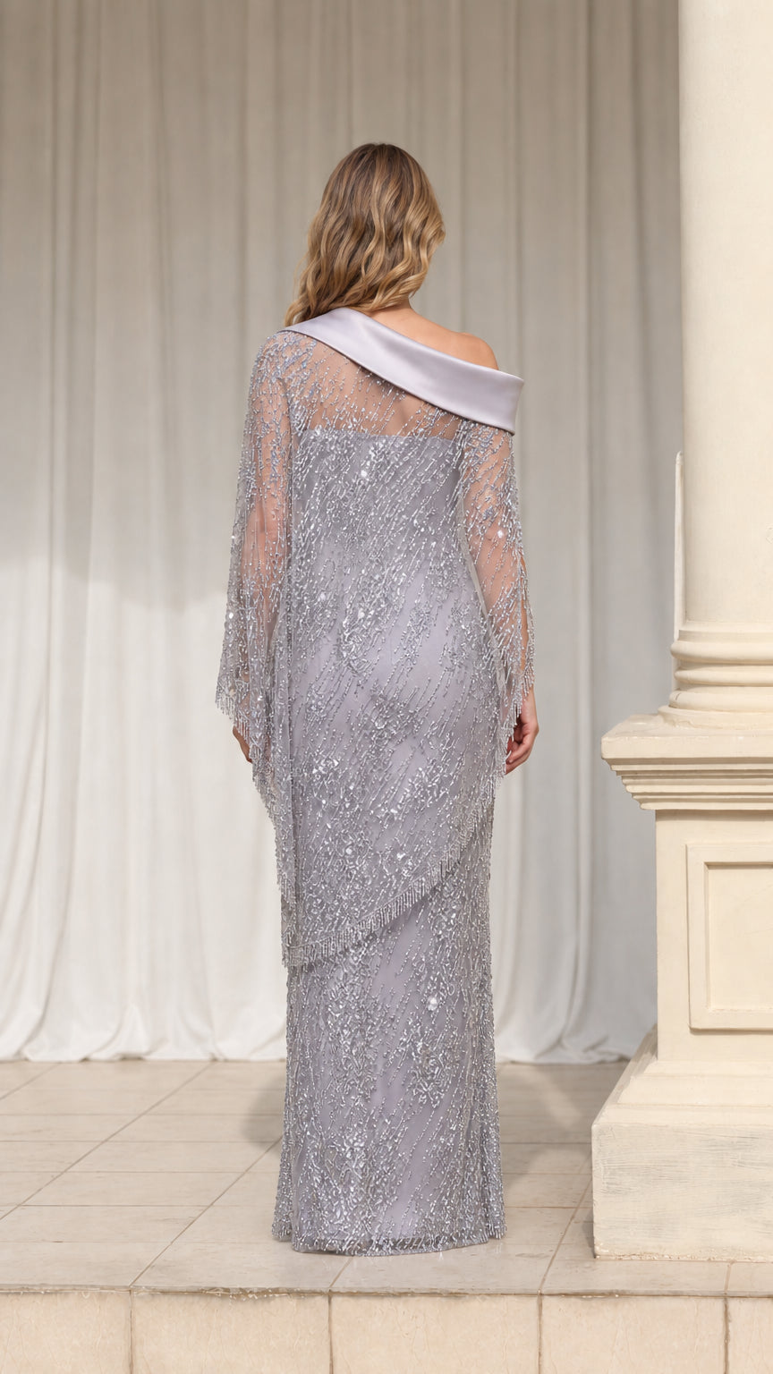 Back view of silver sequin column maxi dress with satin neckline accent
