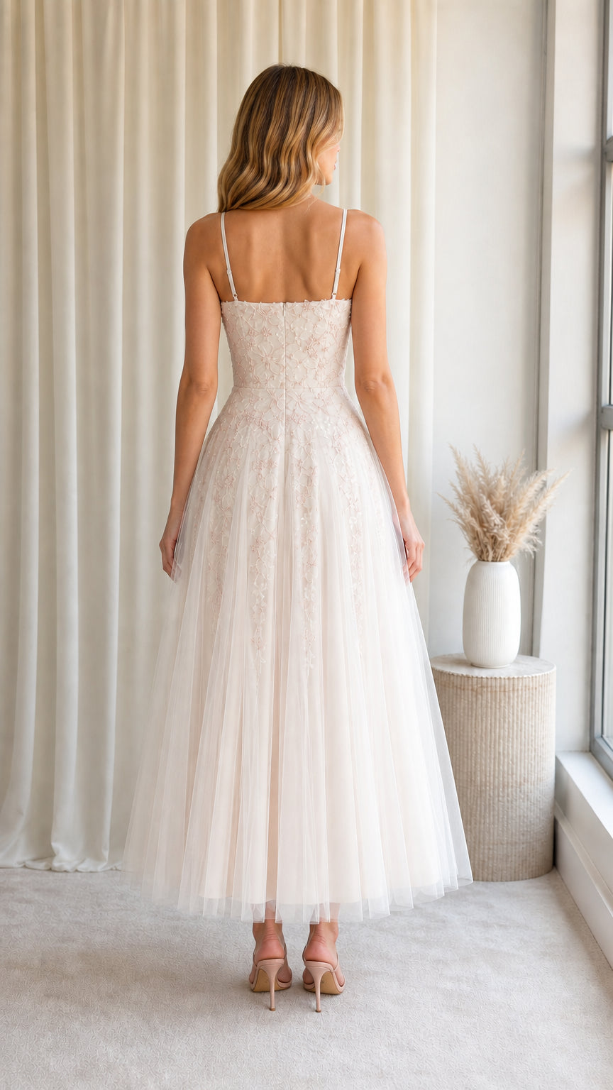 Back view of model wearing Blush Ivory spaghetti strap A-line tulle midi gown
