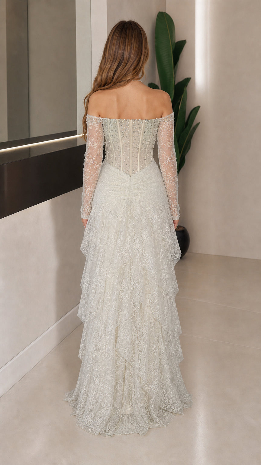 Back view of white tiered lace evening gown