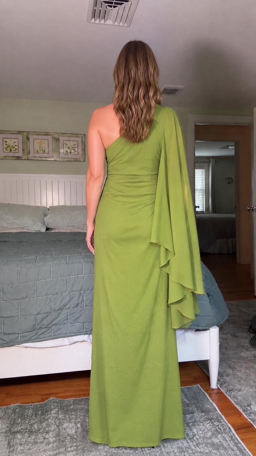 Back view of olive green one-shoulder maxi evening dress with draped cape