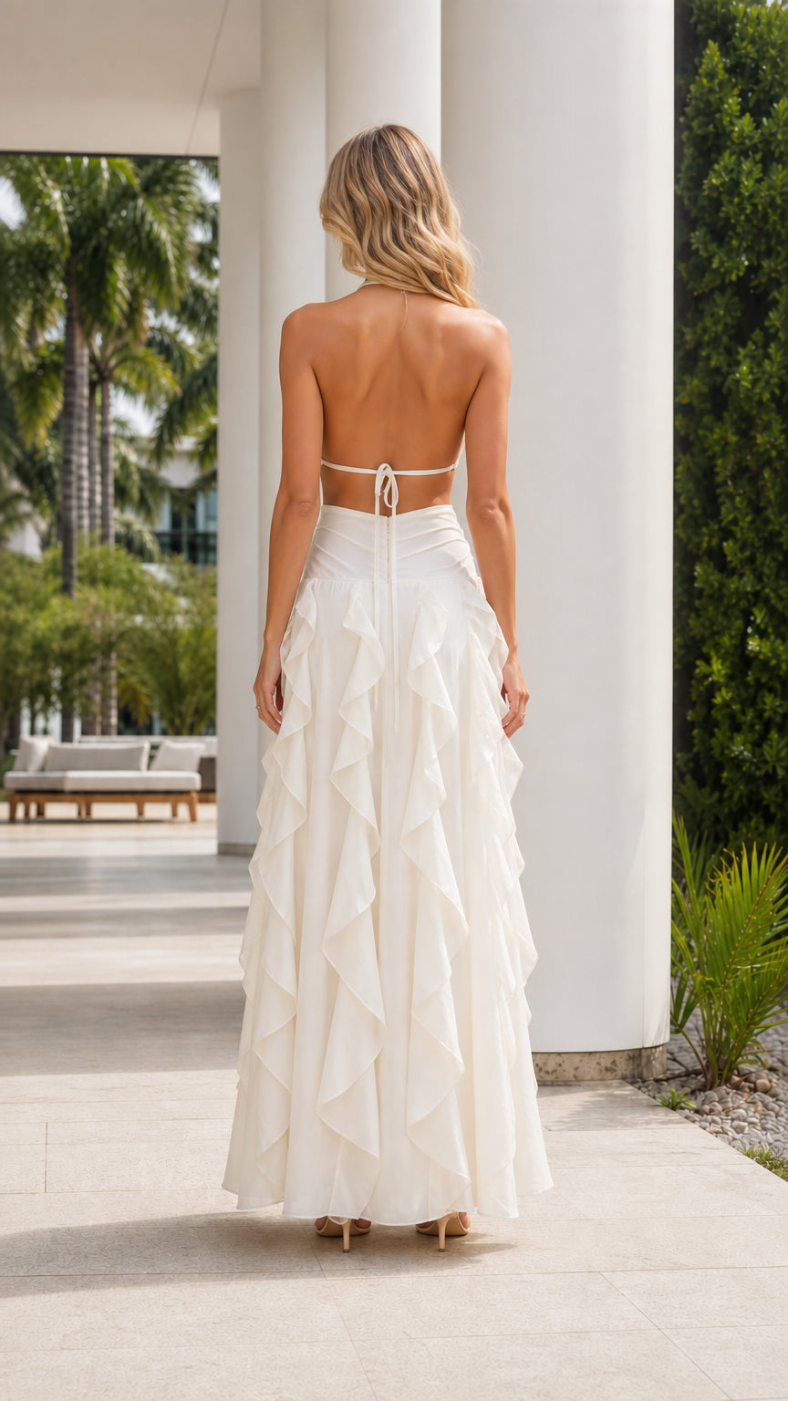 Back view of ivory backless halter maxi dress with tie detail