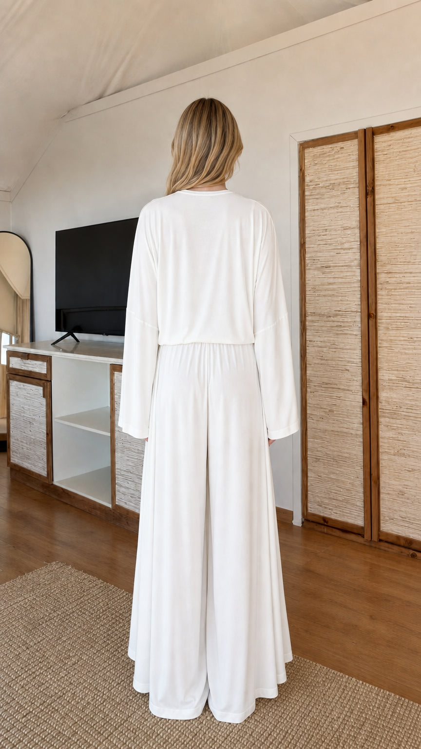Back view of model wearing White 3-piece loungewear set showing fluid drape