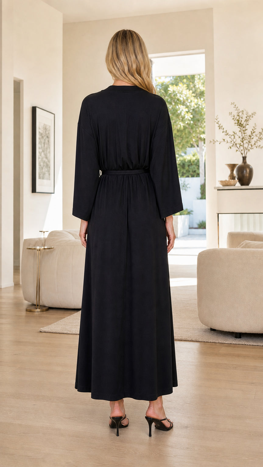 Back view of woman wearing Black floor-length long sleeve robe