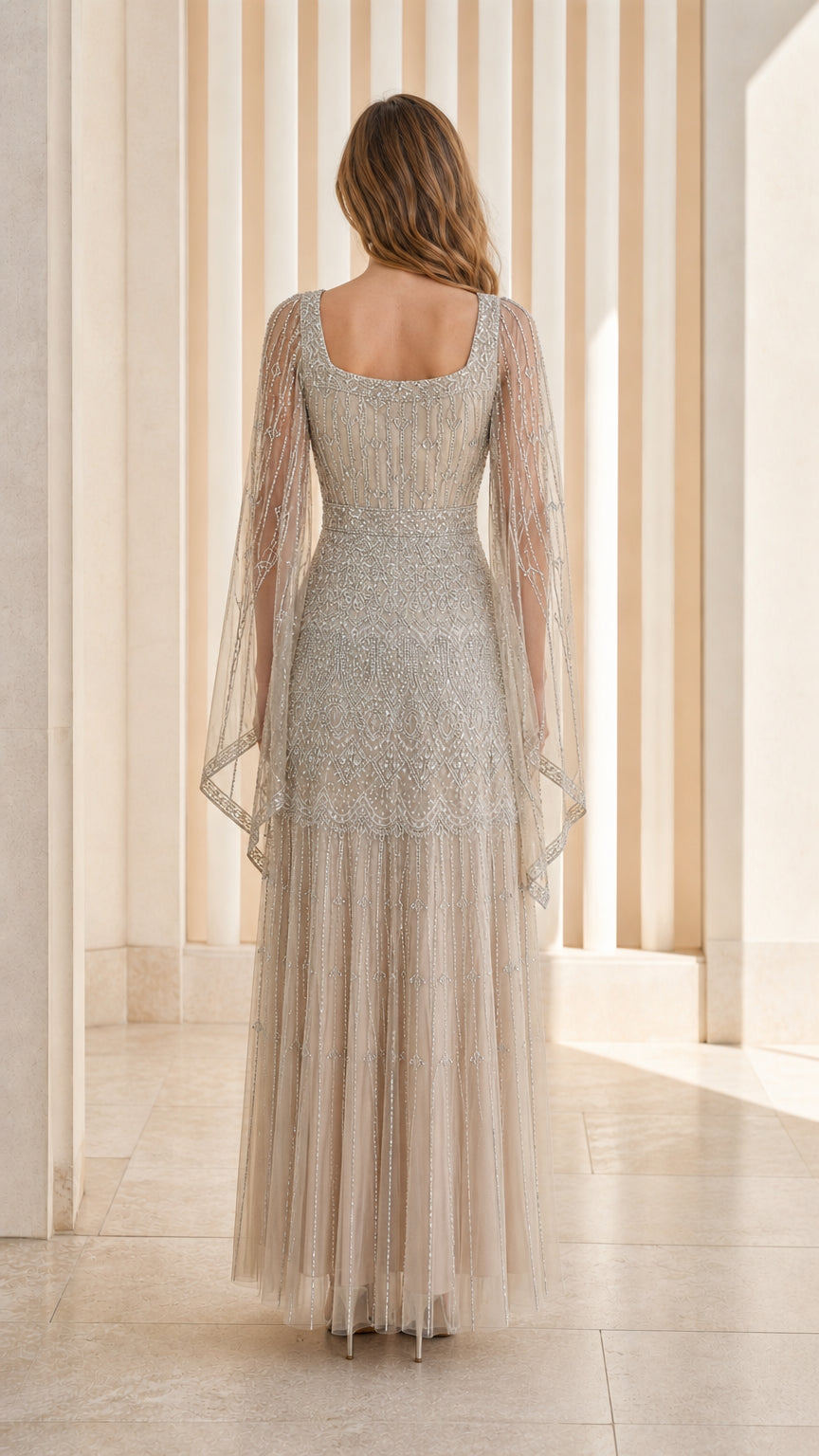 Champagne floor-length formal gown back view with sheer draped sleeves