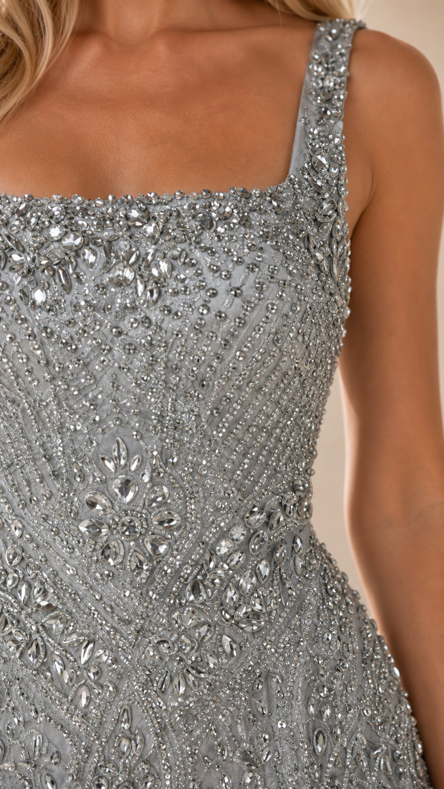Close up view of intricate crystal beadwork and square neckline on cocktail dress