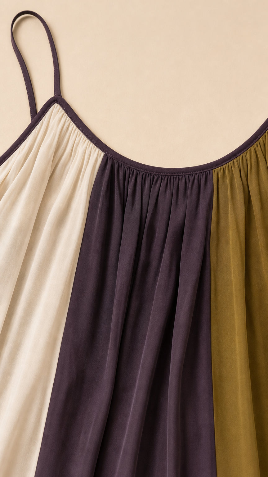 Close-up of the gathered scoop neckline and vertical color-block fabric panels