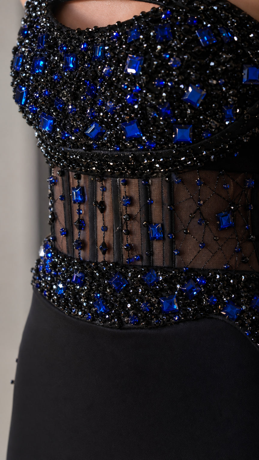 Close-up detail of blue and black crystal beading on sheer bodice