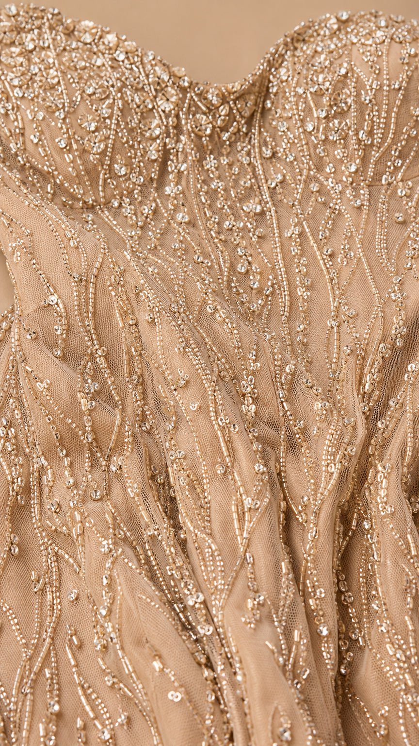 Close-up detail of champagne mesh fabric with intricate sequin and bead embroidery