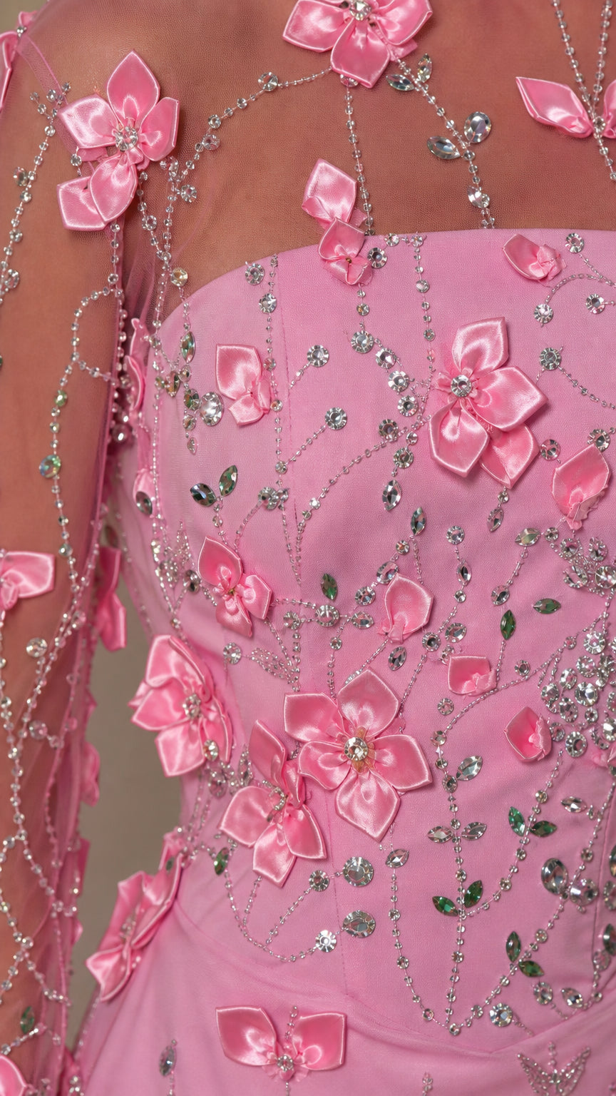 Close-up detail of 3D satin floral appliques and crystal beading on sheer mesh