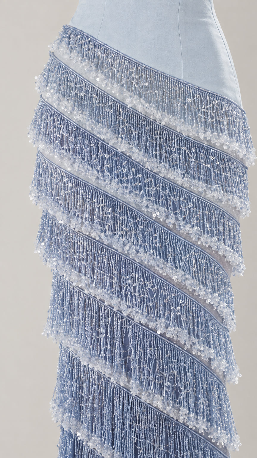 Close-up detail of textured diagonal fringe and beadwork on Light Blue dress