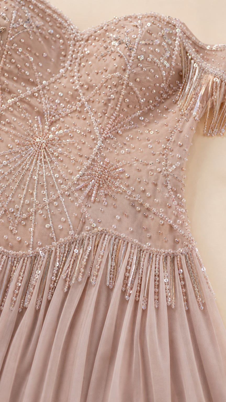 Close-up detail shot of the beaded bodice and sparkly sequin starburst pattern