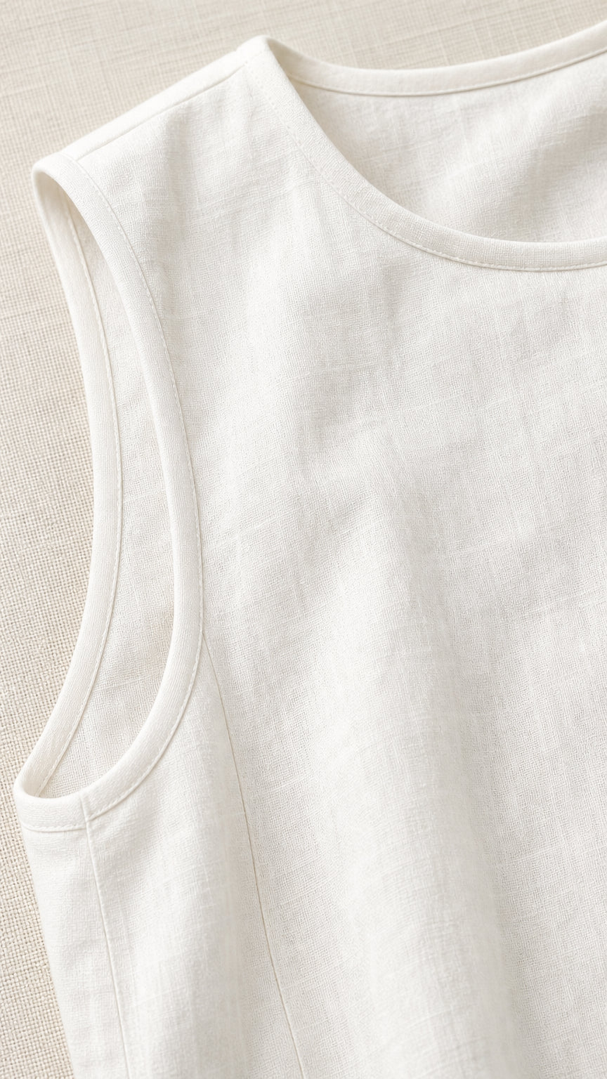 Close-up detail of neckline and textured woven linen fabric