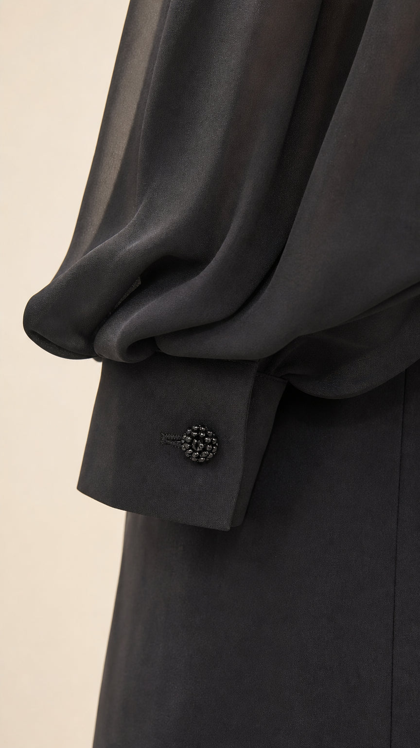 Close-up of sheer bishop sleeve and buttoned cuff detail
