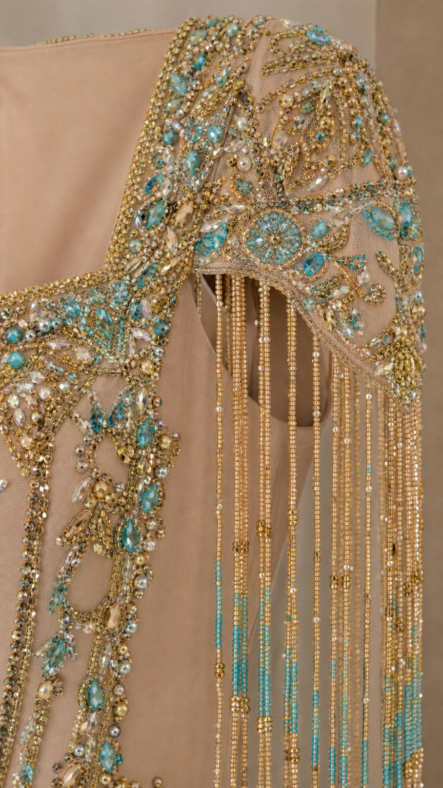 Close-up of intricate crystal beadwork and fringe on shoulder