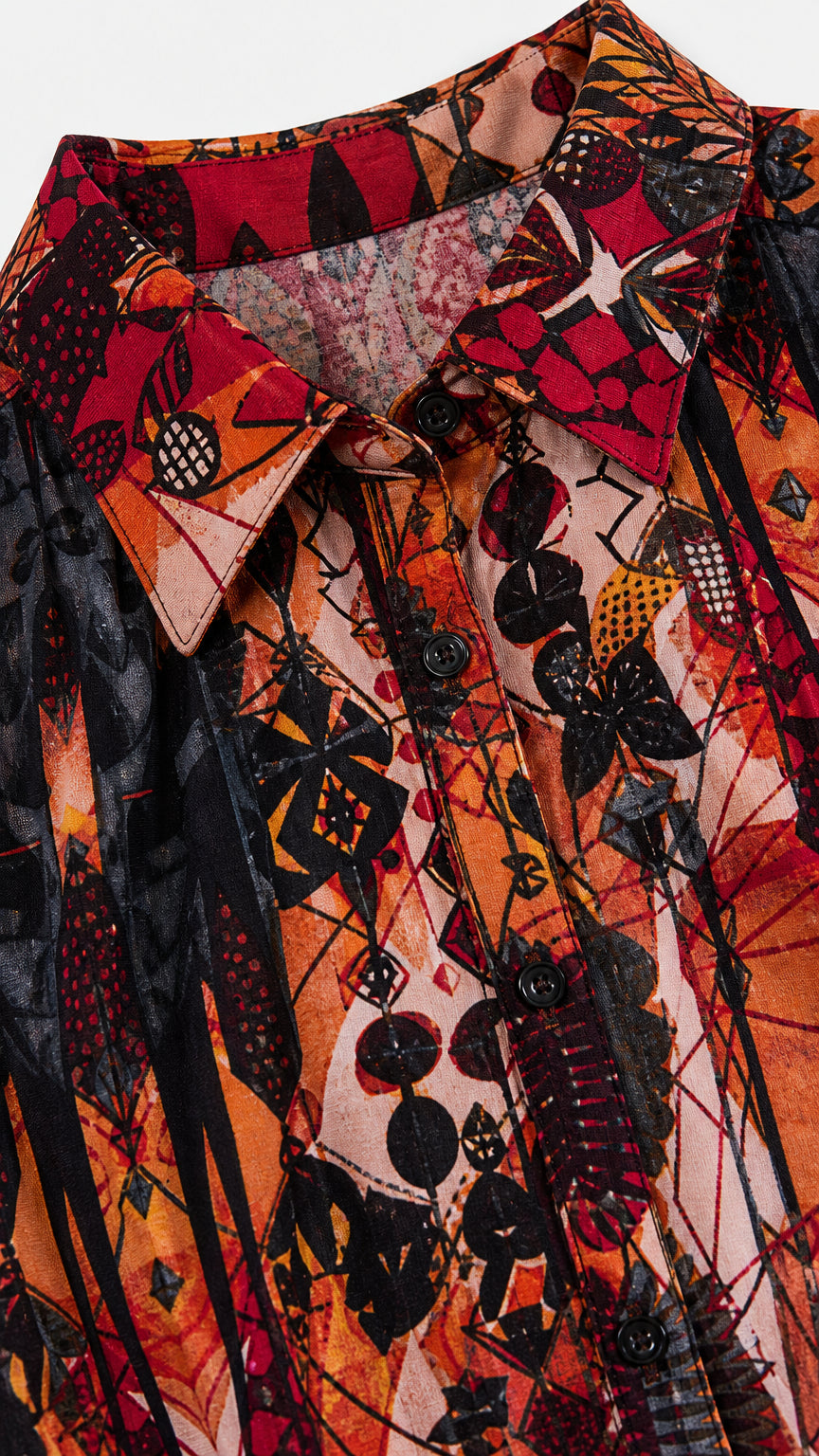 Close-up detail of shirt collar, buttons, and geometric pattern on rust orange maxi dress