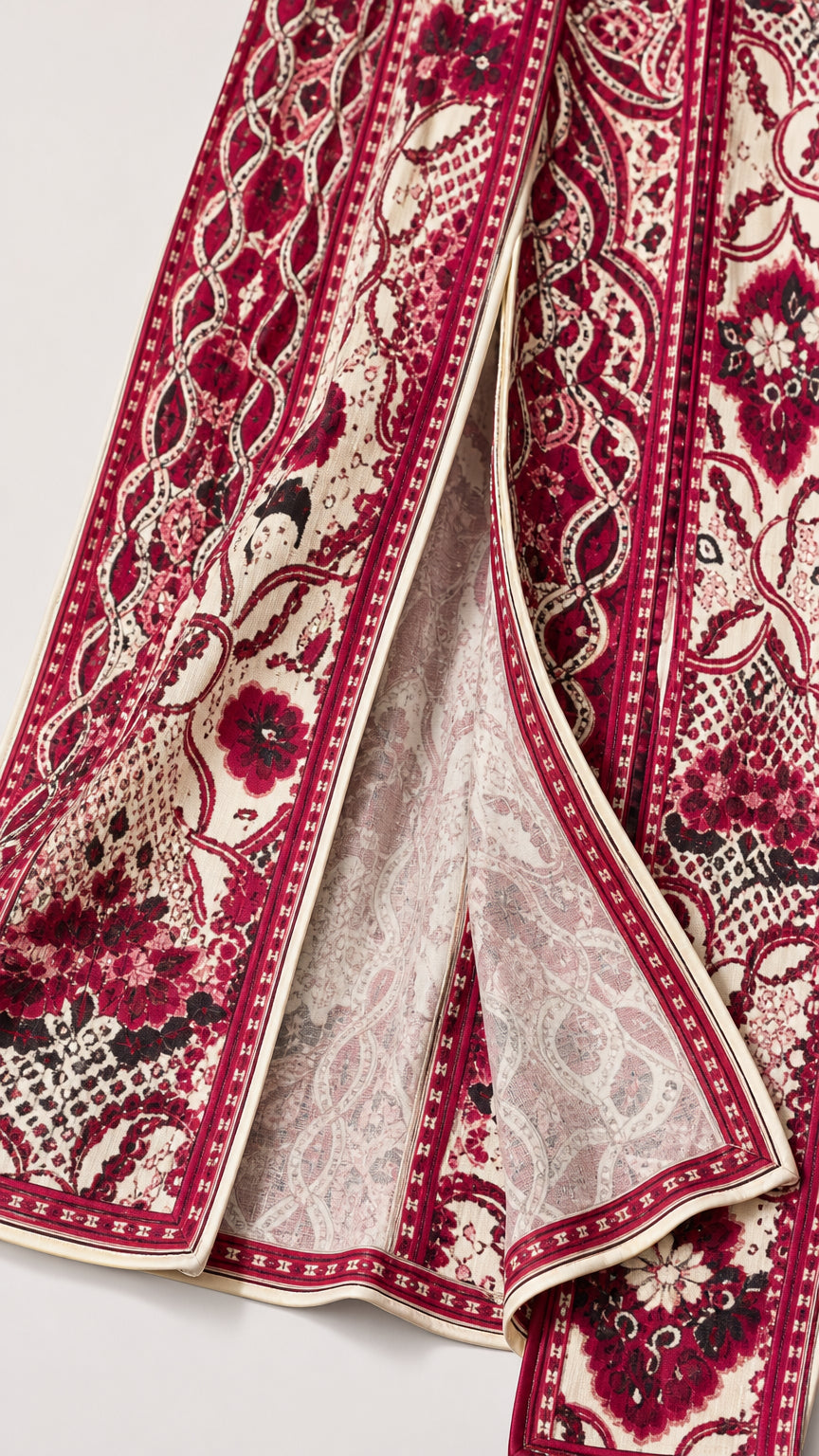 Close-up detail of the textured floral jacquard knit fabric and finished split hem