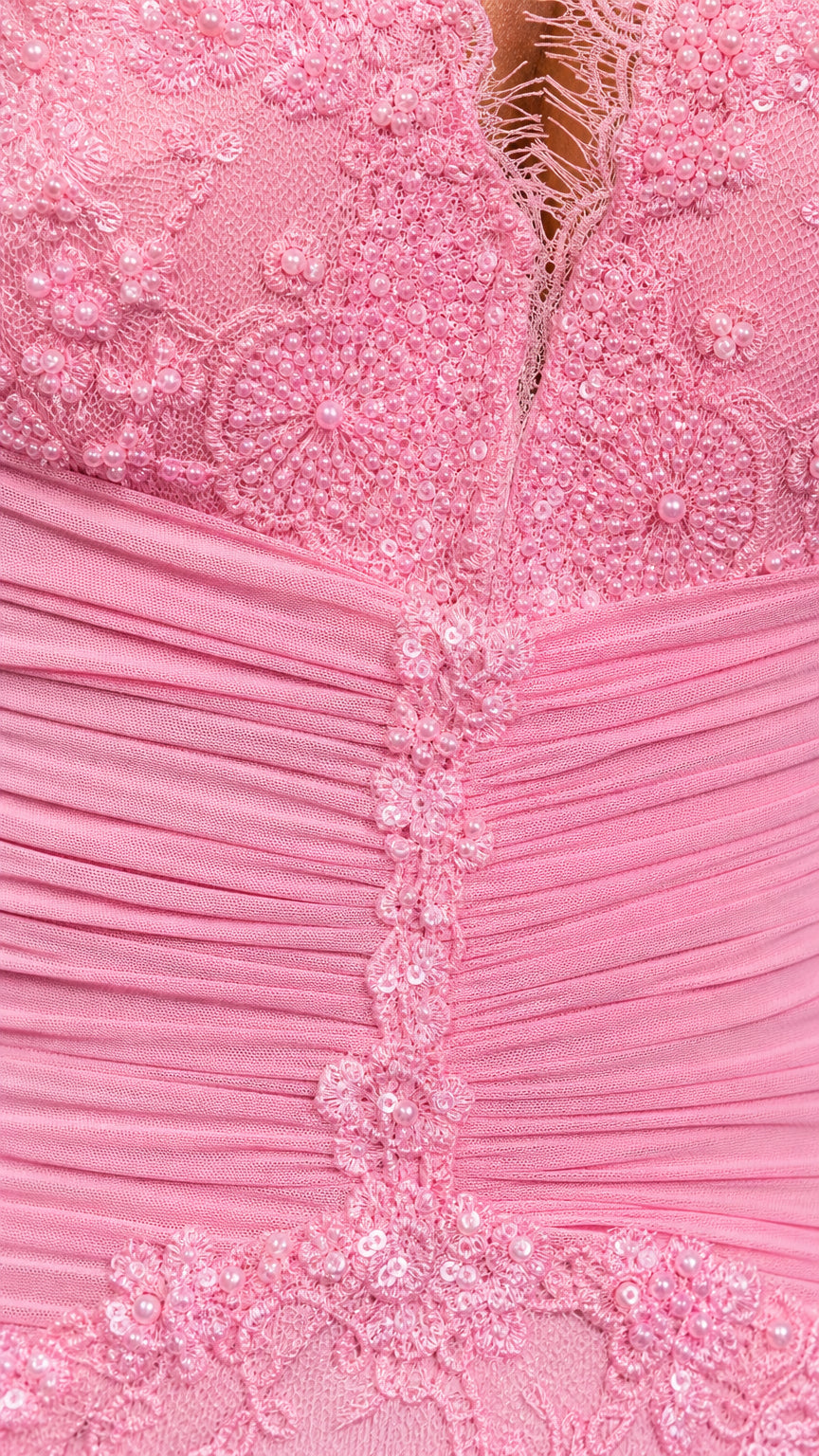 Close-up detail of lace texture and ruched bodice on pink dress