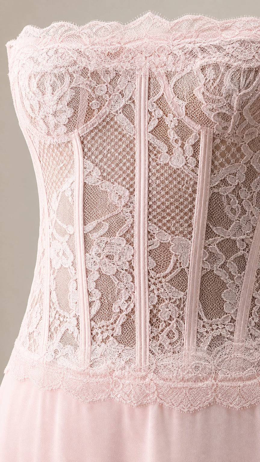 Close-up detail of blush pink floral lace bodice with boning structure