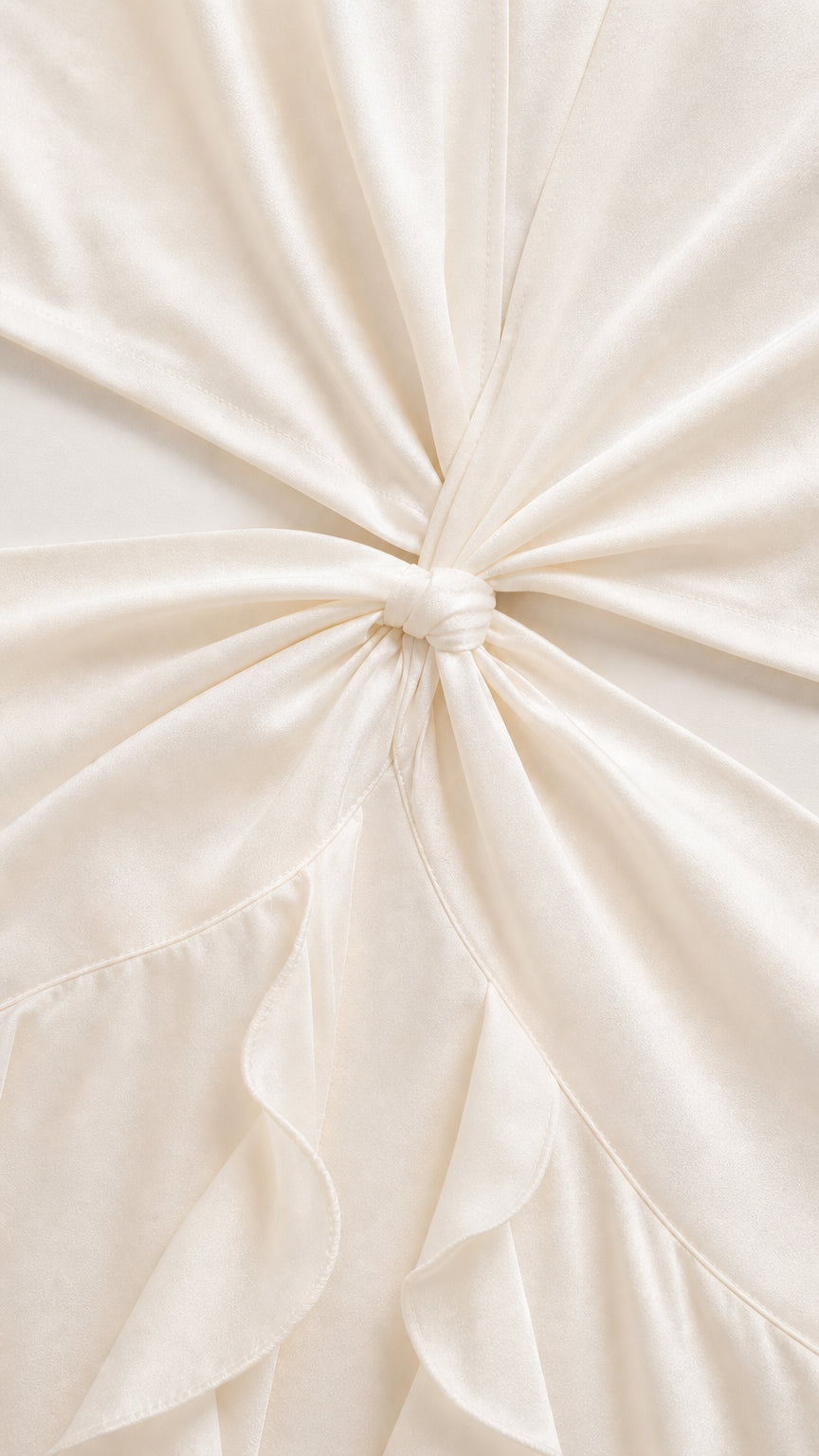 Close-up detail of knot waist cutout and ruffled fabric