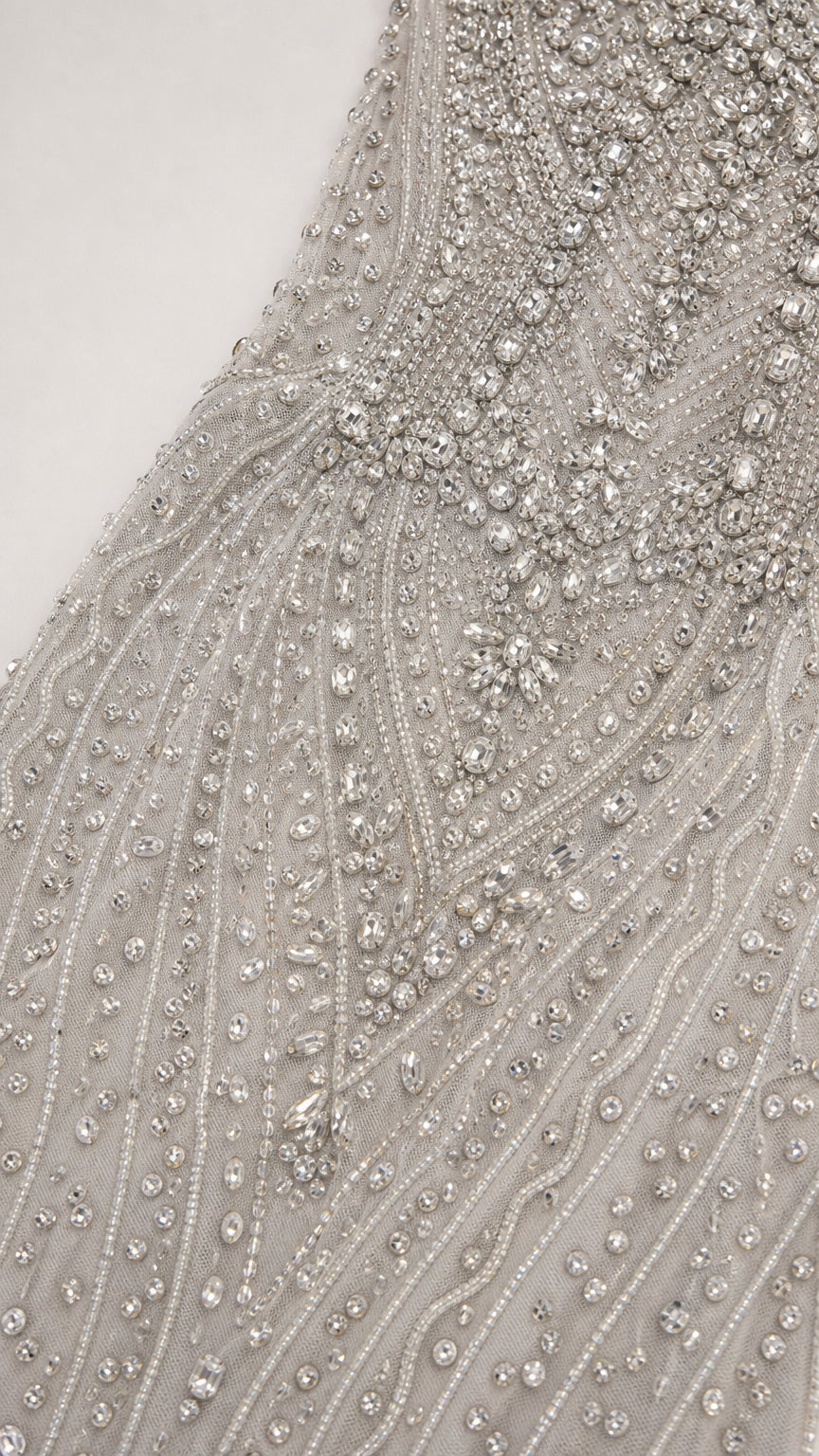 Close-up detail of intricate silver beadwork and crystal embellishments