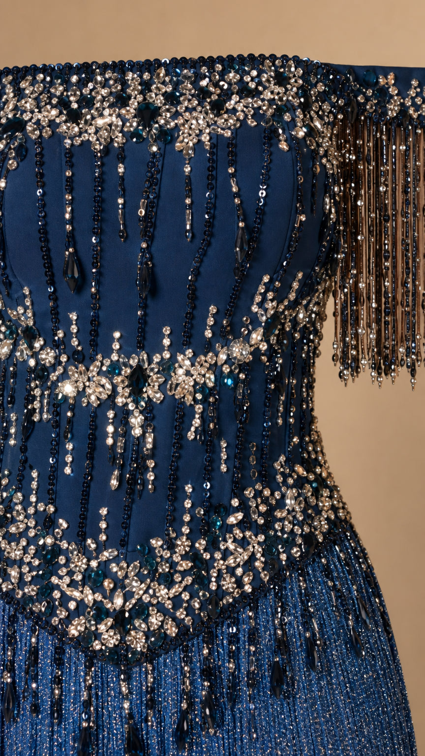 Close-up detail of bodice beadwork and fringe sleeves