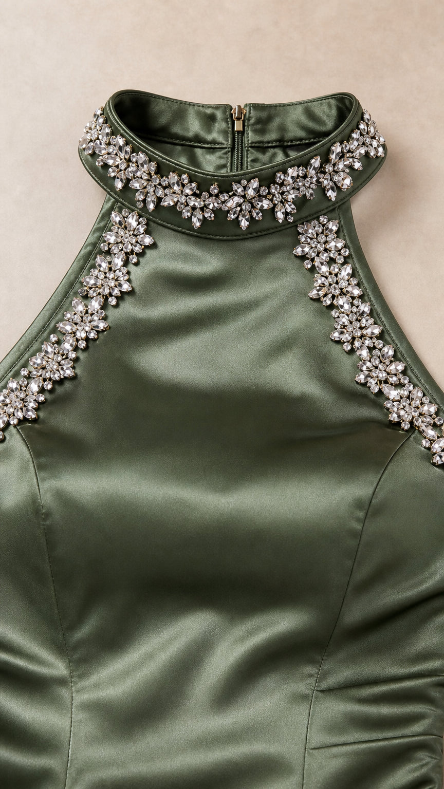 Close-up detail of rhinestone and crystal beading on olive green satin neckline