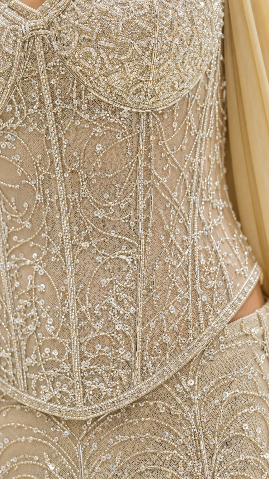 Close-up detail of the intricate bead and sequin pattern on the bodice